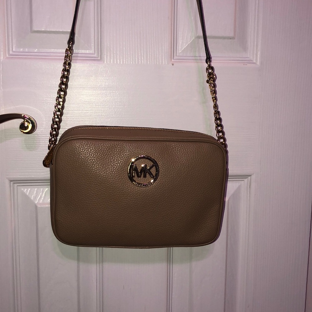 A tan MK cross body.